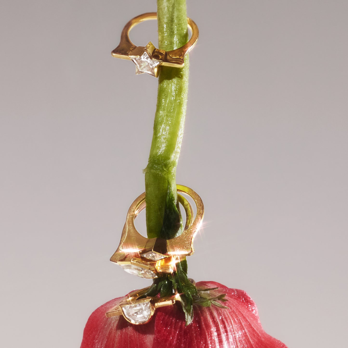 Stacked rings featuring the Highline star-cut lab-grown diamond ring in yellow gold, displayed on a rose stem.