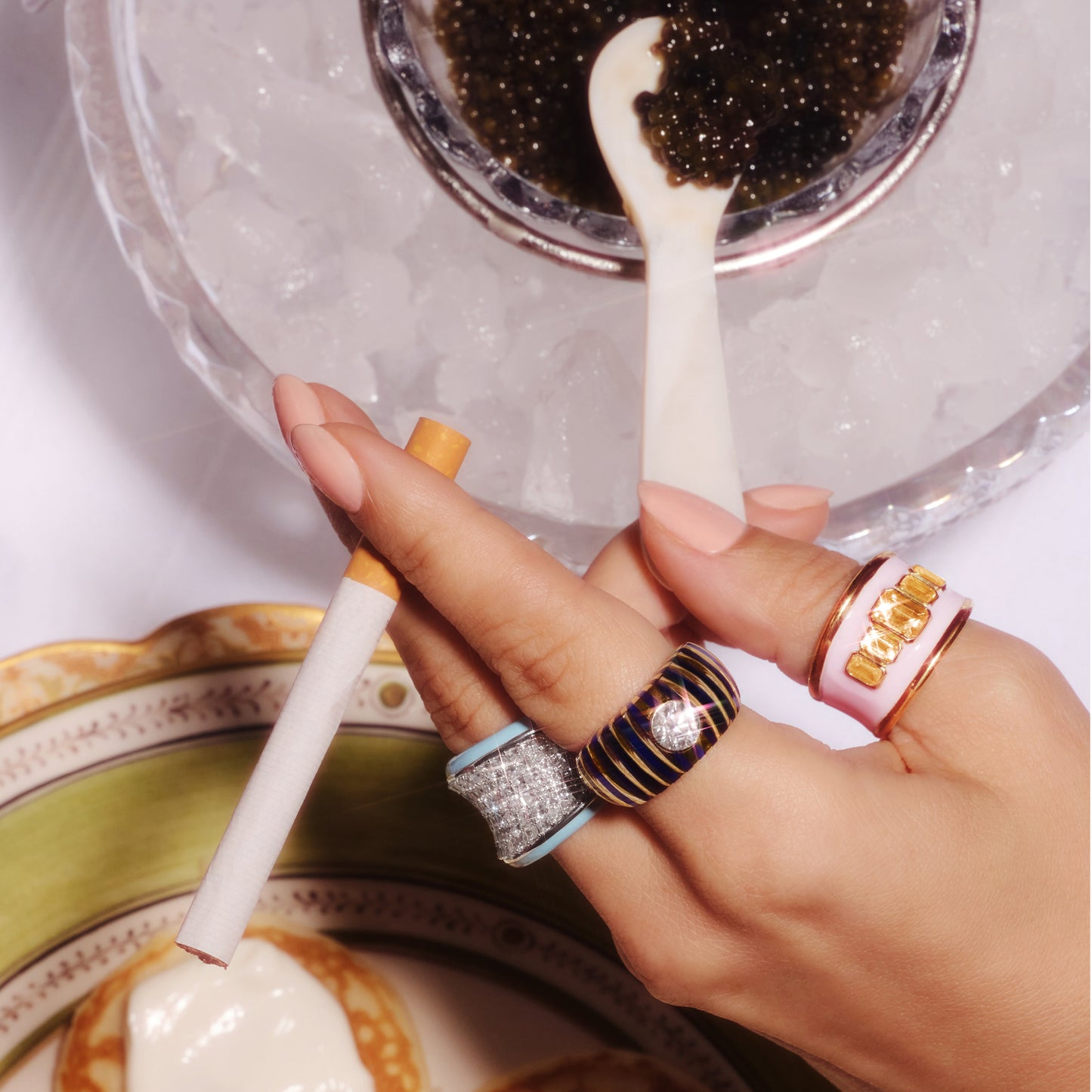 Navy blue ceramic and 18ct yellow gold ring with 1ct bezel-set round lab-grown diamond, worn on a hand.