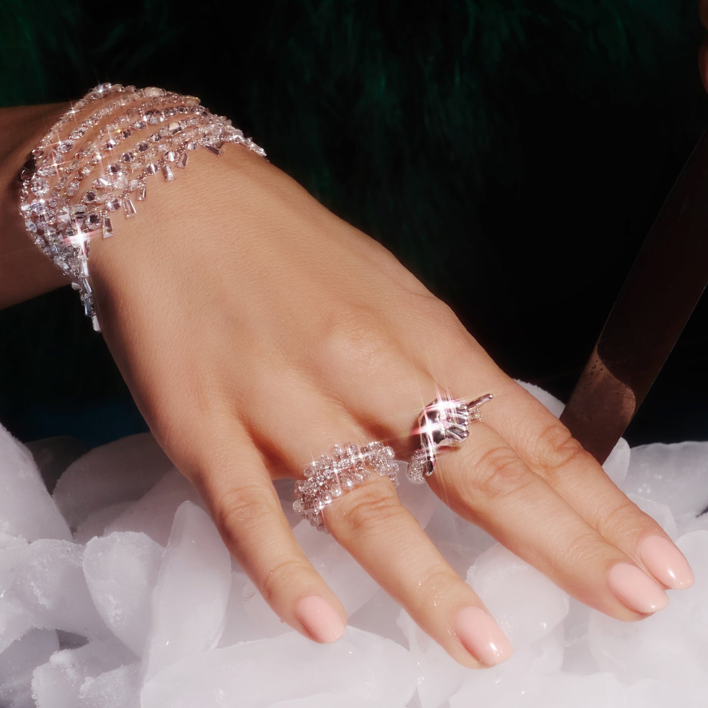 18ct white gold ring with ruby-detailed gold hand, worn on a hand and surrounded by pavé lab-grown diamonds.